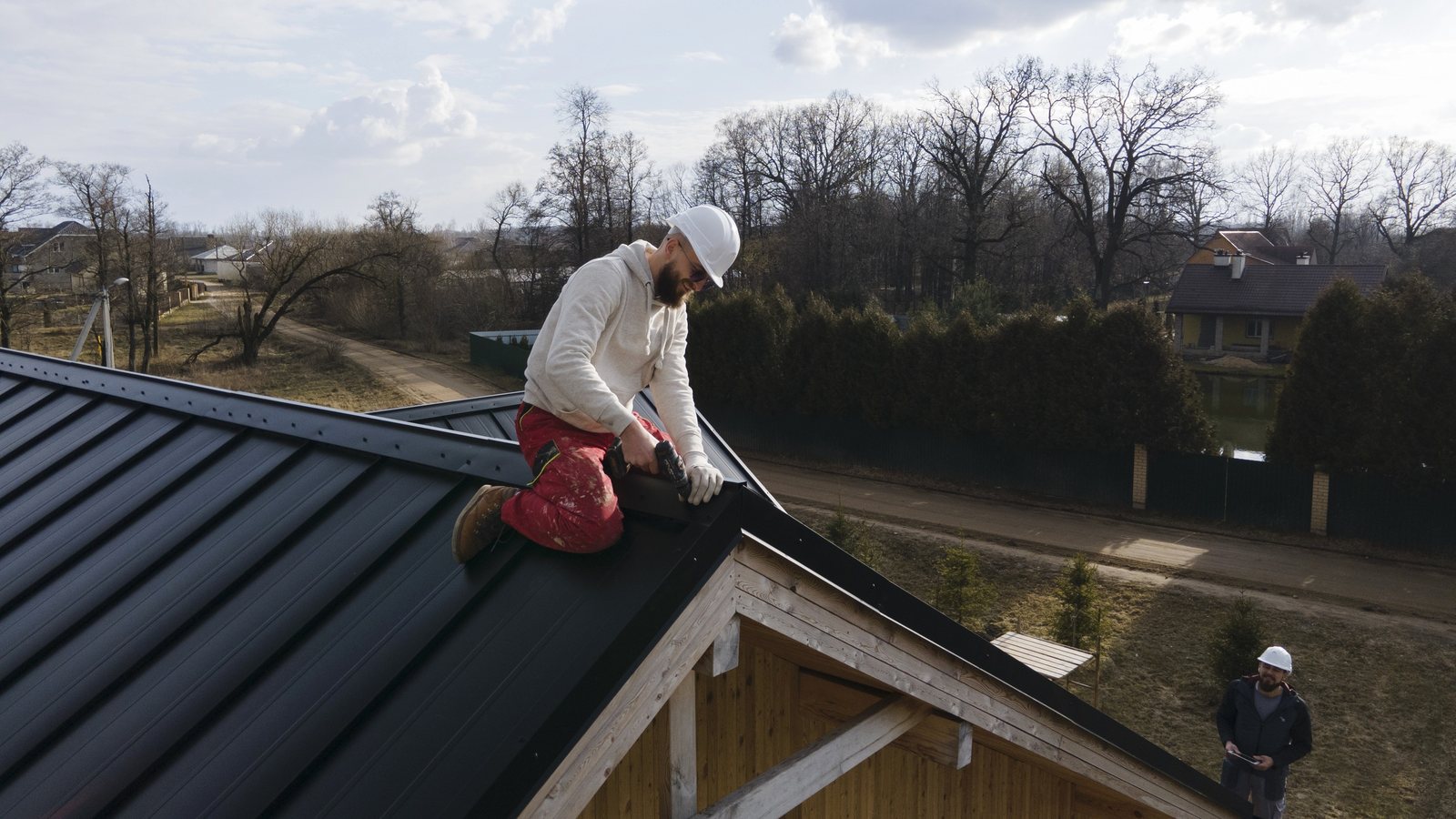 Roofer installing shingles on a residential roof